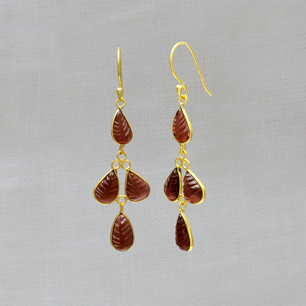 Dangle drop earrings featuring carved garnet gemstones in a simple 18k gold vermeil setting, with a hook fitting. 
