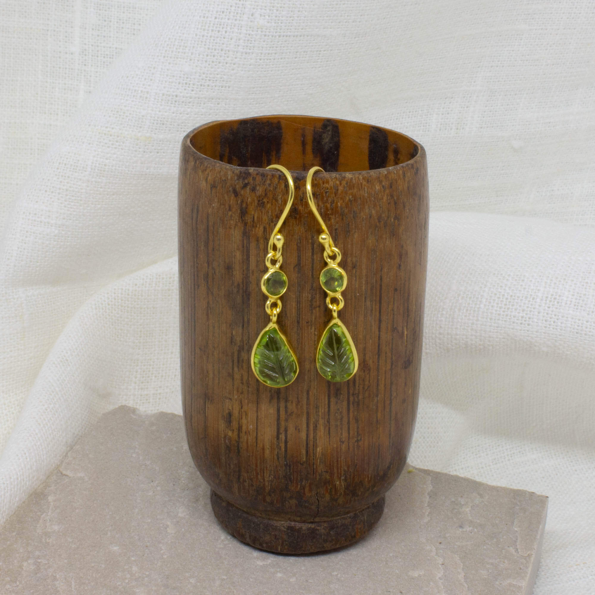 Carved and faceted peridot gemstone earrings in 18k gold vermeil with a simple hook fitting - Beyond Biasa