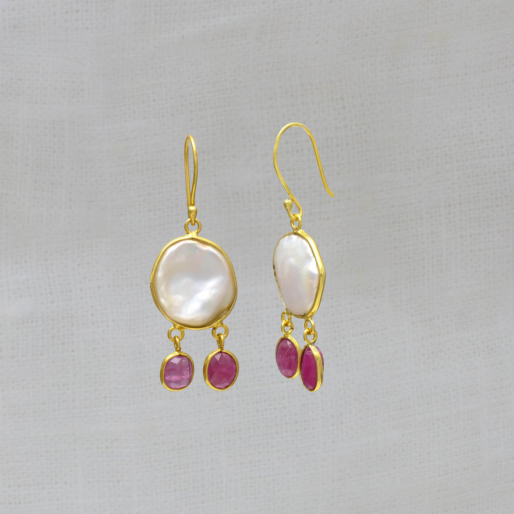 Drop Earrings featuring irregular biwa pearls in a simple 18k gold vermeil setting with two ruby gemstones hanging below and a hook fitting