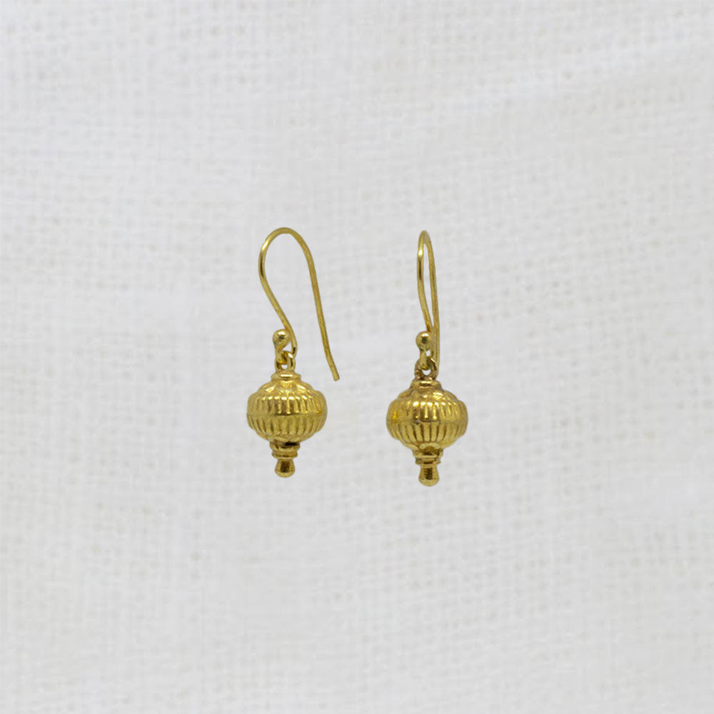 Pair of gold earrings on a white background