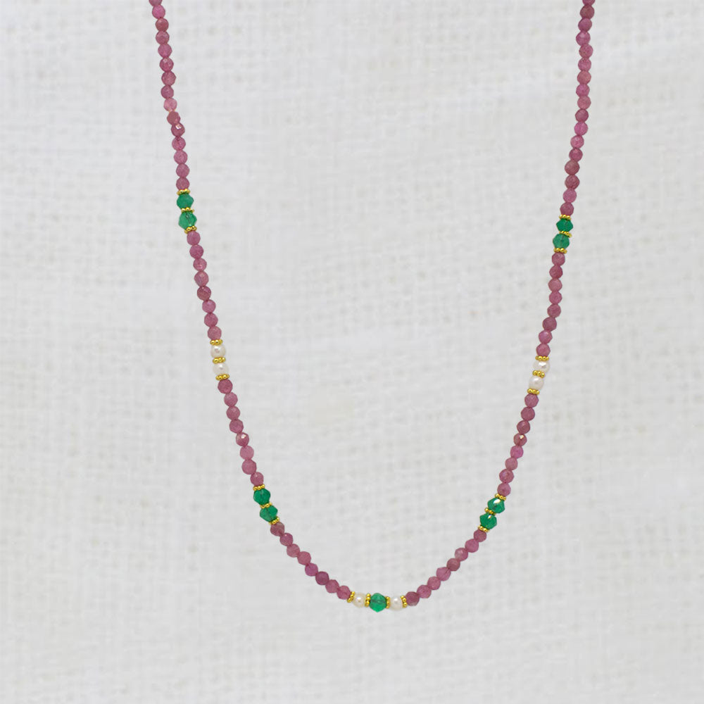 Necklace with pink tourmaline and green onyx beads on a white background
