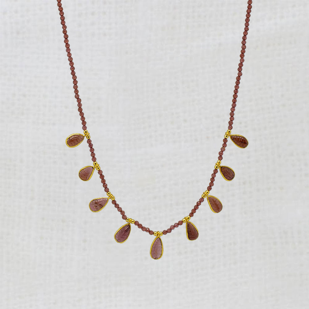 Garnet Necklace with red beads and gold accents on a white background