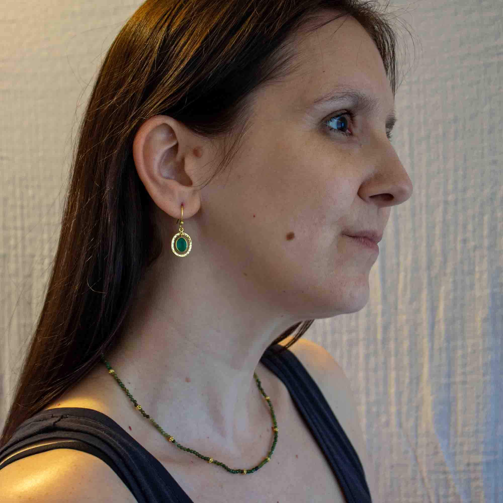 Model wearing Green onyx gemstone and 18k gold vermeil hammered oval drop earrings with hook fittings - Beyond Biasa