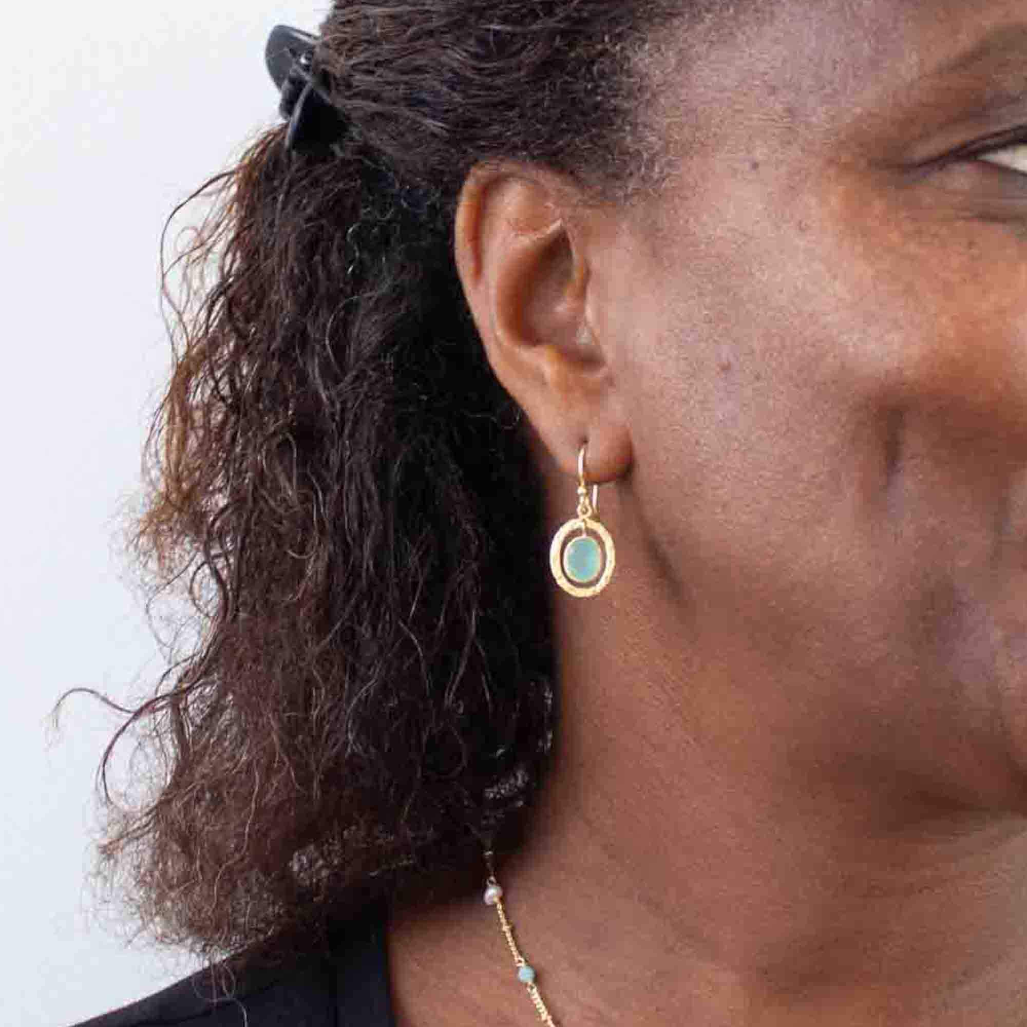 Model wearing Aqua chalcedony gemstone and 18k gold vermeil hammered oval drop earrings with hook fittings - Beyond Biasa