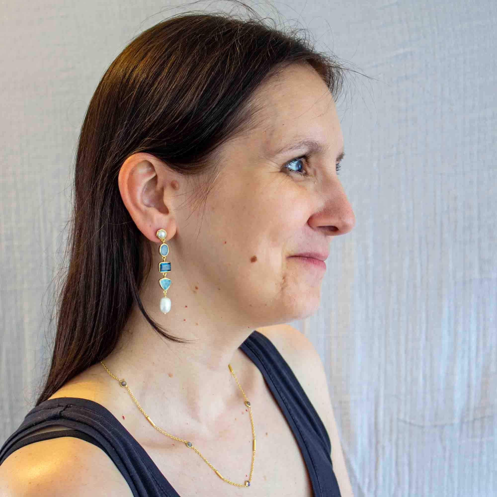 Model wearing Long gemstone multi stone dangle earrings in 18k gold vermeil, with freshwater pearl, blue chalcedony and kyanite - Beyond Biasa