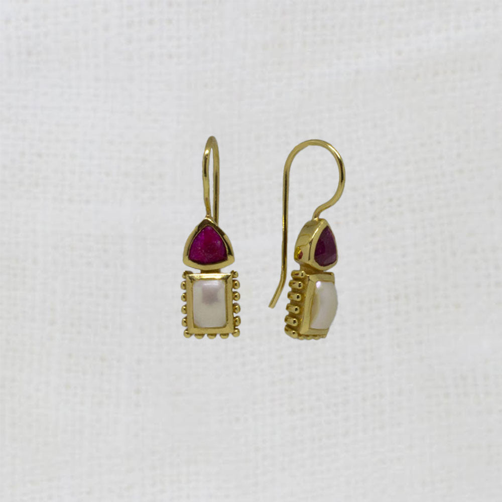 Gold earrings with red ruby gemstones and pearls on a white background | beyond biasa