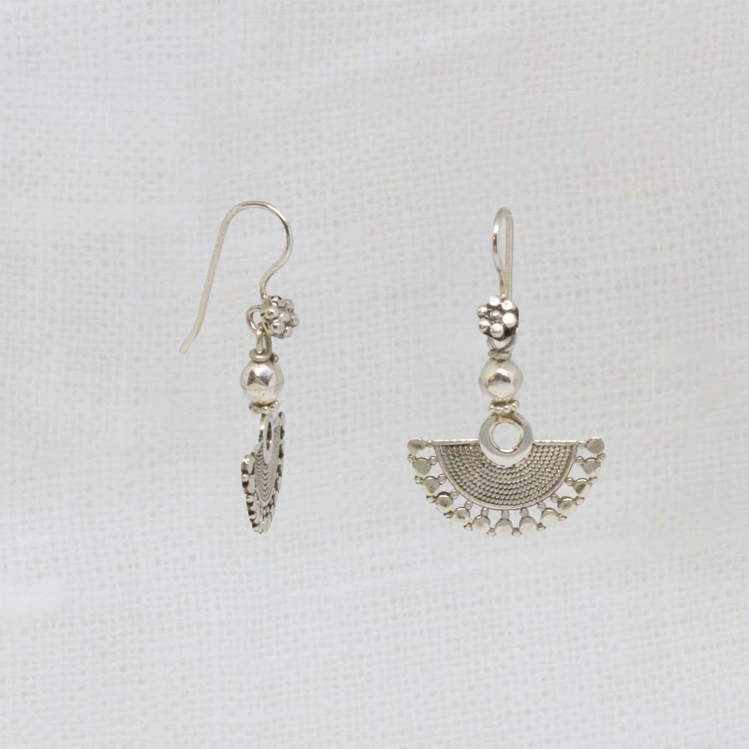 Small sterling silver fan shaped earrings, handmade with a detailed wirework finish and hook fittings | Beyond Biasa