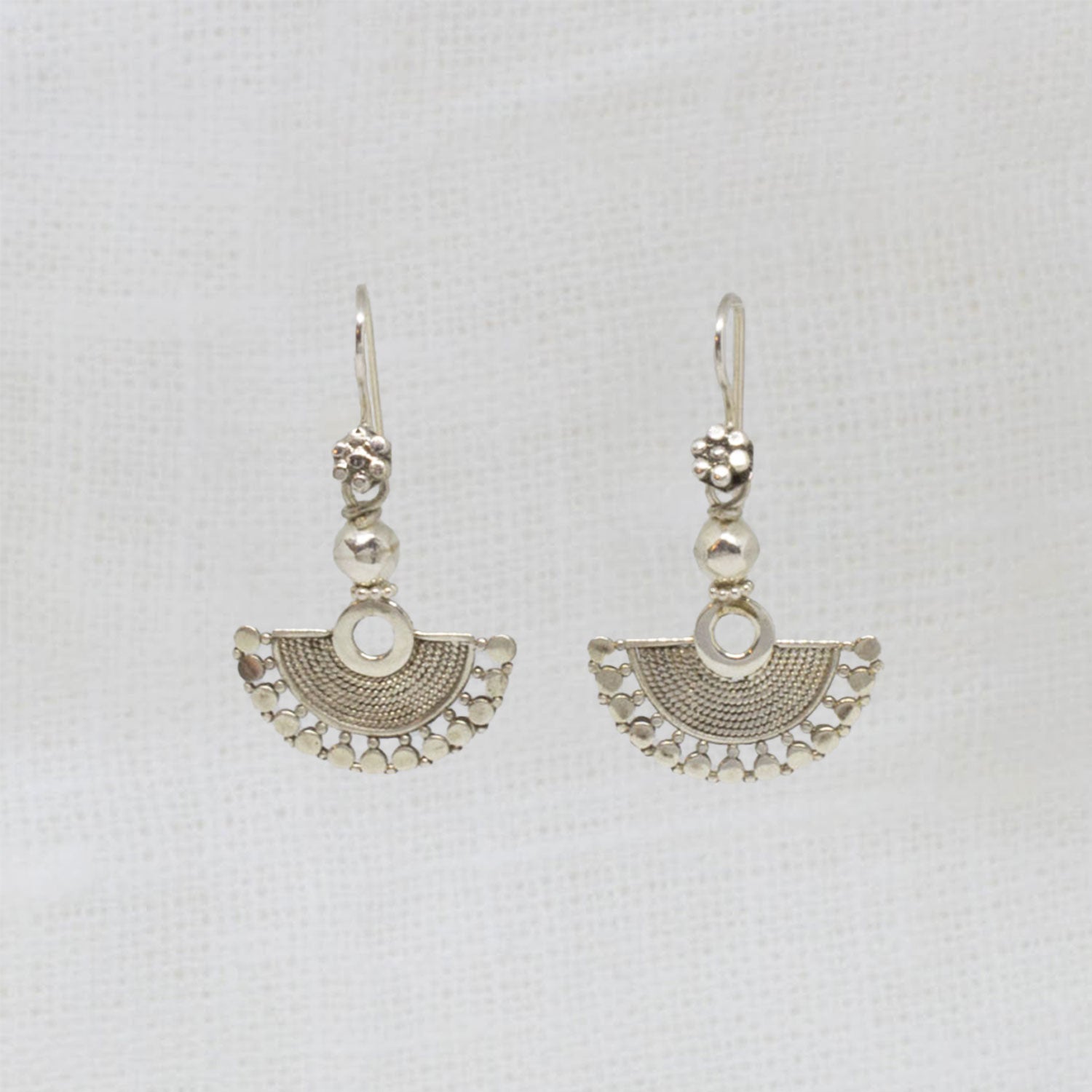 Small sterling silver fan shaped earrings, handmade with a detailed wirework finish and hook fittings | Beyond Biasa