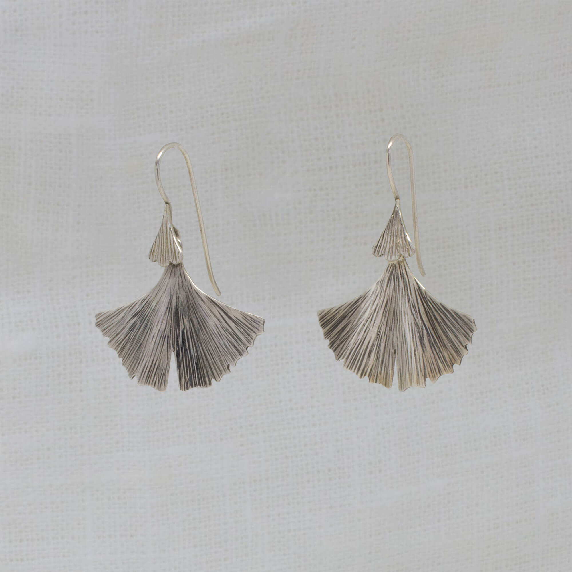 Sterling silver oxidised and textured fan shaped ginkgo leaf earrings with a hook fitting - Beyond Biasa