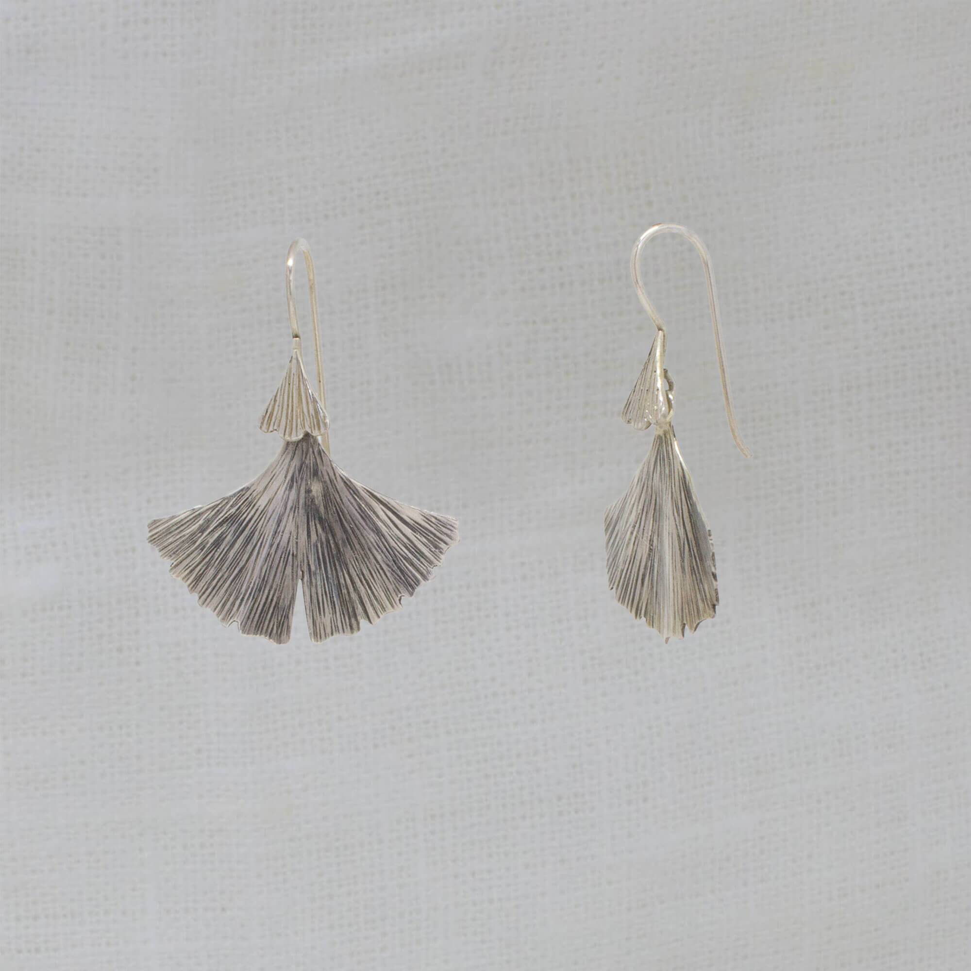 Sterling silver oxidised and textured fan shaped ginkgo leaf earrings with a hook fitting - Beyond Biasa