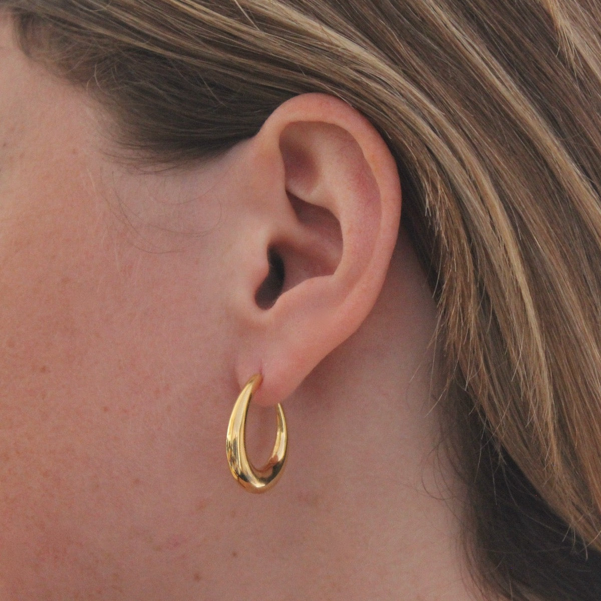 Model wearing Minimal 18k gold vermeil tapered hoop earrings with stud fitting | Beyond Biasa