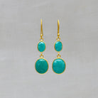 A pair of dangle drop earrings featuring two oval shaped amazonite gemstones set in a simple 18k gold vermeil setting with hook fitting