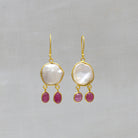 Drop Earrings featuring irregular biwa pearls in a simple 18k gold vermeil setting with two ruby gemstones hanging below and a hook fitting