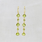 Gold vermeil peridot cascade long drop earrings with teardrop adn round gemstones and a hook fitting