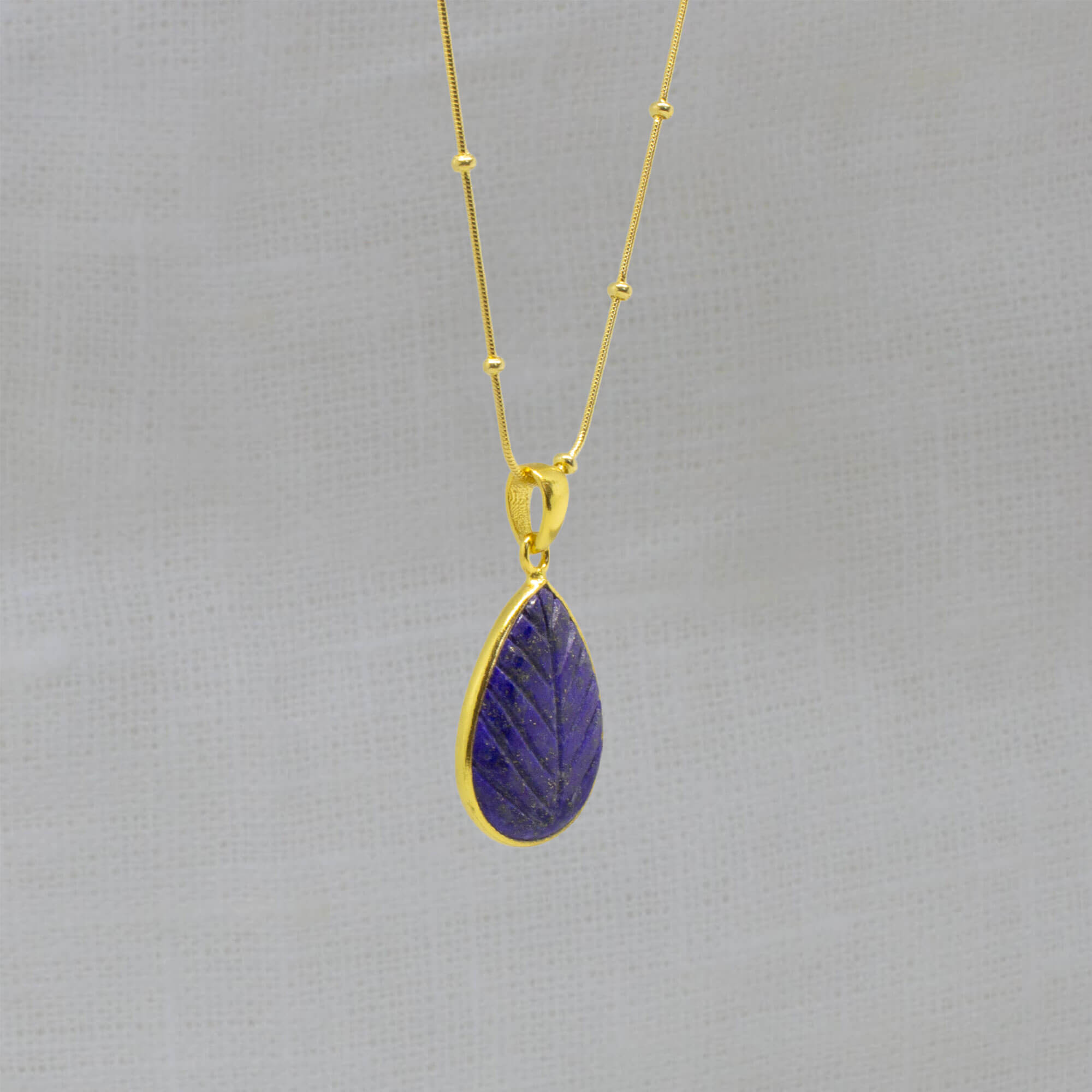 Carved blue lapis lazuli and gold vermeil gemstone pendant necklace with adjustable gold studded snake chain - Beyond Biasa