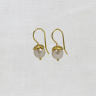 Round white freshwater pearl earrings with gold vermeil hooks and flower cap | Beyond Biasa