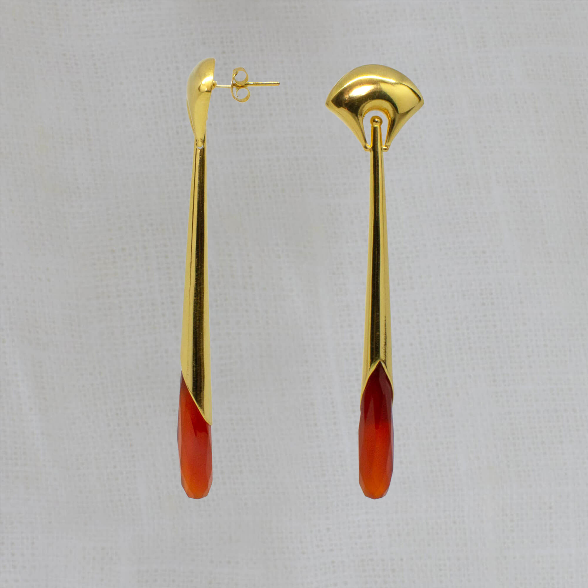 Long statement earrings in 18k gold vermeil with a curved stud and long drop with faceted carnelian gemstone