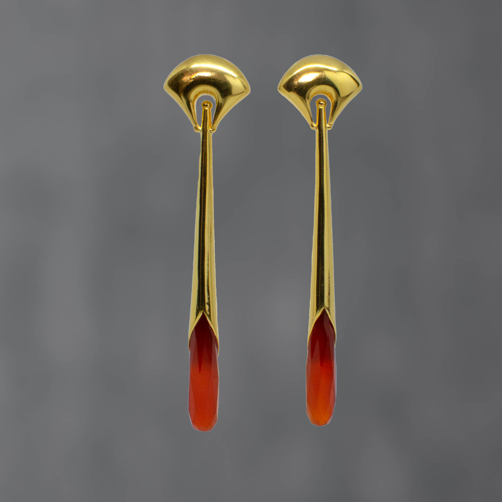 Long statement earrings in 18k gold vermeil with a curved stud and long drop with faceted carnelian gemstone