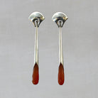 Long statement earrings in sterling silver with a curved stud and long drop with faceted carnelian gemstone