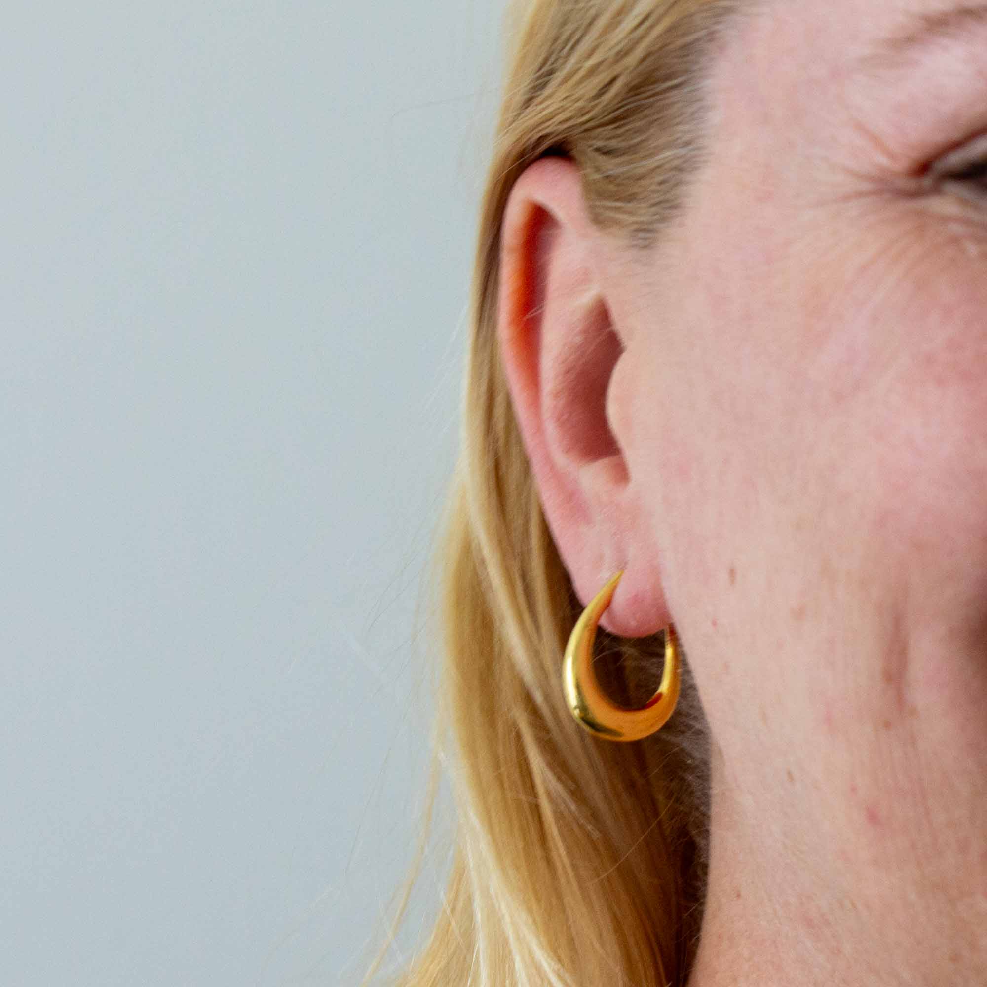 Model wearing Minimal 18k gold vermeil tapered hoop earrings with stud fitting | Beyond Biasa