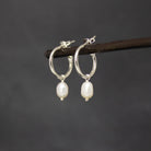 Sterling Silver hoop earrings with white freshwater pearl charms and a stud fitting - Beyond Biasa